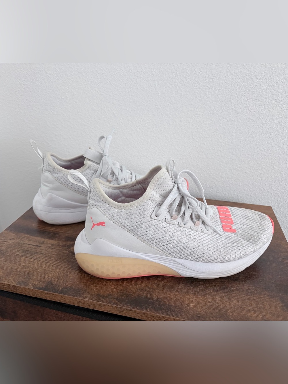 Women's white Puma knit sneakers with orange logo